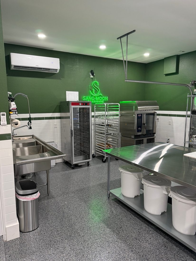 The Bakehouse kitchen with oven, baking racks and stainless steel worktable
